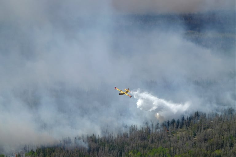 A water bomber drops a load on the Nopiming Provincial Park wildfire EA061 east of Bird River, Manitoba, Canada May 29, 2025. Manitoba Government/Handout via REUTERS. THIS IMAGE HAS BEEN SUPPLIED BY A THIRD PARTY
