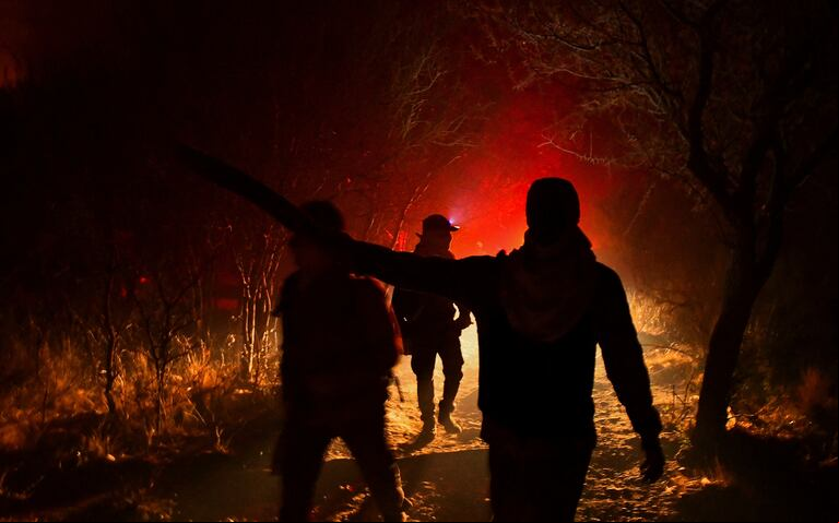 Brigadiers are seen working during a wildfire in Dolores, in the province of Cordoba, Argentina September 19, 2024. REUTERS/Charly Soto NO RESALES. NO ARCHIVES