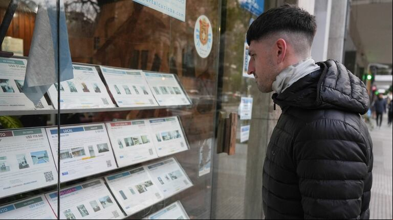 Un joven mira la vidriera de una inmobiliaria. (Foto: NA)